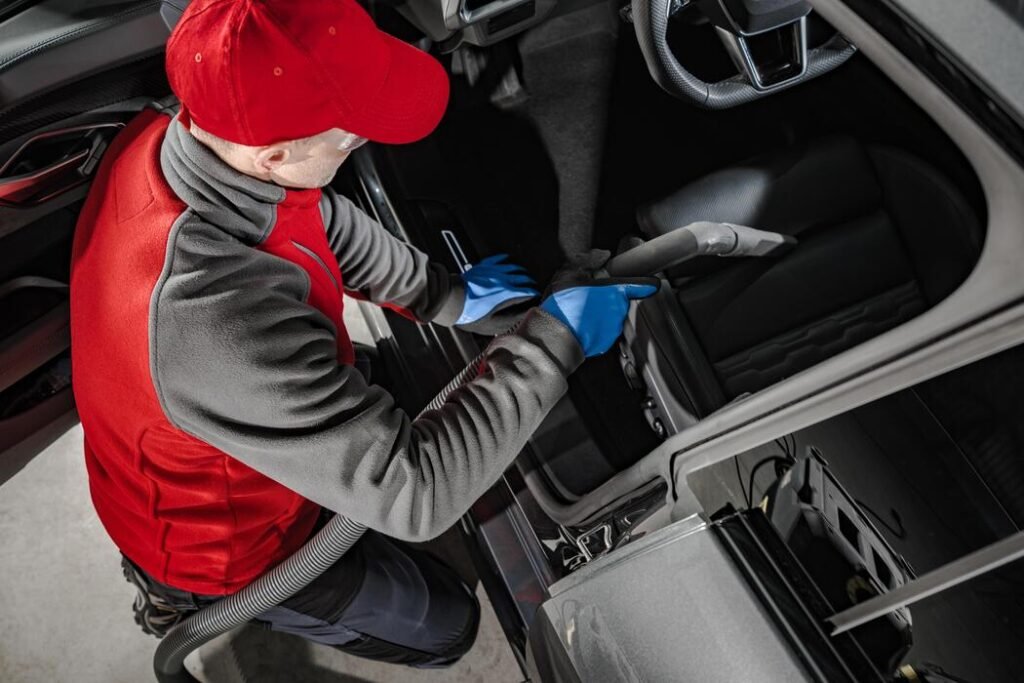 automotive-service-worker-cleaning-car-interior-photo-1